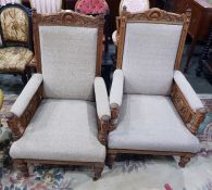 Two Edwardian walnut framed upholstered elbow chai