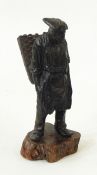 Bronzed figure of a man carrying wicker basket, st