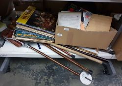 Collection of walking sticks, umbrellas, shooting