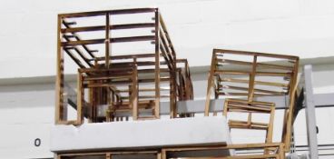 Four rose-coloured metal glass-topped table nests