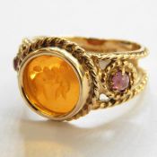 9ct gold dress ring set with oval polished malachite stone, a gold-coloured dress ring set oval