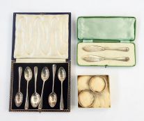 Boxed set of silver teapoons, rat tail pattern, two silver table napkin rings and a pair of beaded