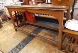 20th century altar style table in the Gothic manner, the rectangular top over a moulded arch, raised