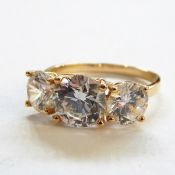 14K yellow gold and three-stone ring set three white stones, a 14K yellow gold dress ring set single