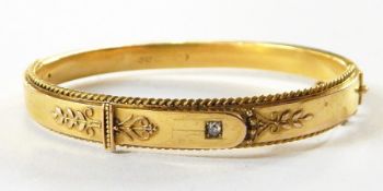 Victorian 15ct gold bangle of buckle-type design, applied bead and scroll border and inset brilliant