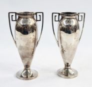 Pair of early 20th century silver vases with Greek key handles, ovoid bodies to circular feet,