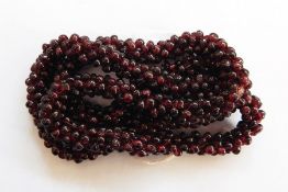 String of amber polished beads and gold-coloured metal necklace with central amber-coloured bead,