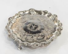 Small silver salver, circular with scallopshell and scroll raised border, the centre crest