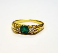 Gold coloured metal emerald and diamond ring, square cut emerald (with chip to corner) flanked by