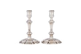 A pair of early George II cast silver candlesticks by Thomas Causton