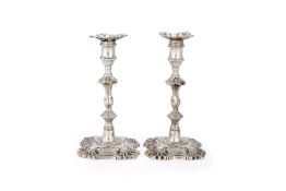 A pair of early George III cast silver candlesticks by John Hyatt & Charles Semore