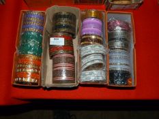 Four Boxes of Assorted Asian and Costume Bangles