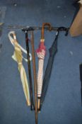 Three Umbrellas and Two Walking Sticks