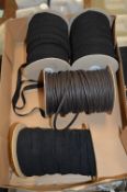 Three Rolls of Elasticated Black and a Roll of Faux Leather Trim