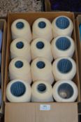 Twelve Cones of Cream Polyester Thread