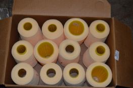 Twelve Cones of Yellow Polyester Thread