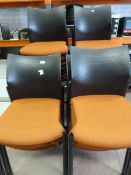 Twenty Five Orange Banqueting Chairs with Black Pl