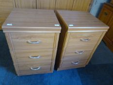 Two Teak Effect Three Drawer Bedside Cabinets