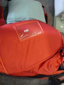 Two Red Holdalls and a Curtain