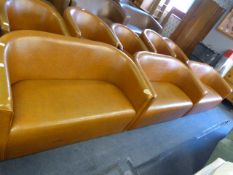 *Three Tan Leatherette Sofa and a Blue Tub Chair