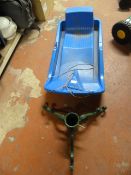Child's Plastic Sled and a Christmas Tree Stand