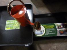 *Four Plastic Garden Trays and a Watering Can