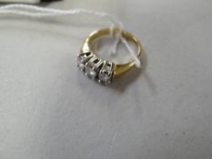 An 18ct gold three-diamond stone ring
