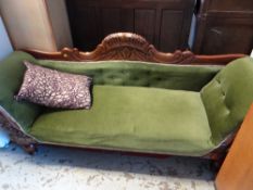 A vintage carved wood framed scroll-end sofa with upholstered carved back