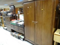 A suite of Stag bedroom furniture comprising two-drawer wardrobe, mirrored dressing table & chest of