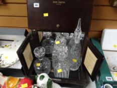 A Remy Martin cognac cabinet together with four various cut glass decanters