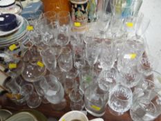 Tray of mixed glassware, painted tin jug, various wall plates etc