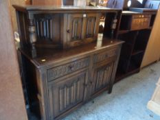 A vintage oak linen fold-style buffet sideboard