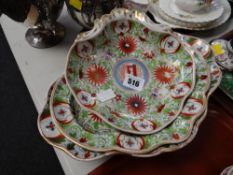 A nineteenth century part dessert-set profusely decorated with green leaves, rust floral motifs