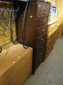 A modern dark wood effect tall narrow chest of seven drawers together with a small modern