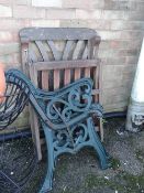 Pair of cast iron green painted garden bench ends together with a wooden folding garden chair (