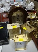 A vintage oak arch-topped mantel clock together with three modern battery carriage clocks
