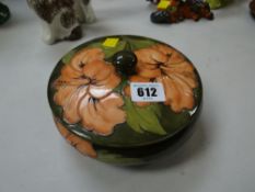A Moorcroft green ground tube-lined floral dish & cover with raised knop, 17cms diam