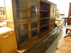 An Old Charm three-section lounge unit with cupboard & drawer bases, central bookshelf flanked by