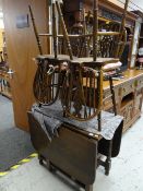 A good vintage oak gate leg dining table together with four matching wheel back loose cushion dining