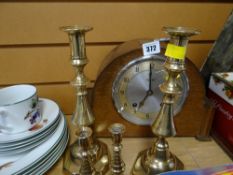 A vintage oak cased domed top mantel clock by Garrard & two pairs of brass candlesticks