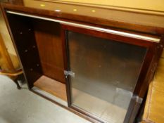A vintage sliding two-glass door narrow dark wood bookcase