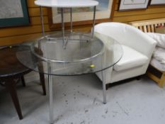 A modern cream leather effect club chair, circular glass top & chrome leg dining table together with