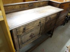 A vintage oak railback sideboard on raised barley-twist supports with two drawers above two