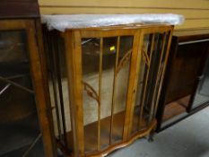 A vintage light mahogany veneer shaped top glass door display cabinet