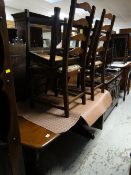 An Ercol refectory-style dining table together with four matching ladderback drop-in cushion