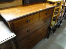 A neat oak chest of drawers on raised feet with two short above three long drawers with copper