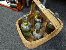 Wicker basket containing four early Purretts Patent Magic fire extinguishers, three with original