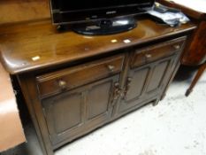 An Ercol dark oak dresser base