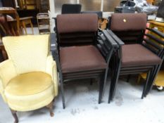 Eight black metal & cushioned office-style chairs together with a small upholstered tub-style