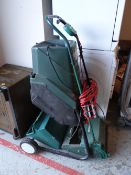 A Black & Decker electric garden shredder together with a Qualcast lawn mower